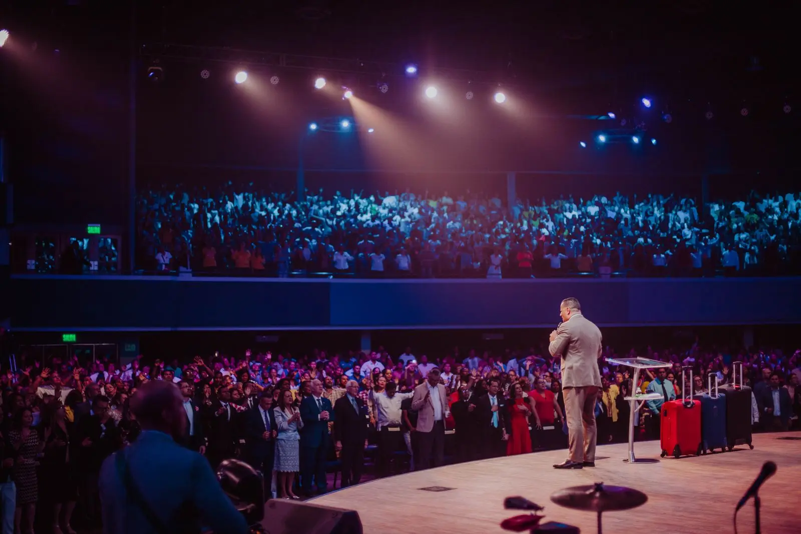 Speaker on a big stage in front of a large crowd