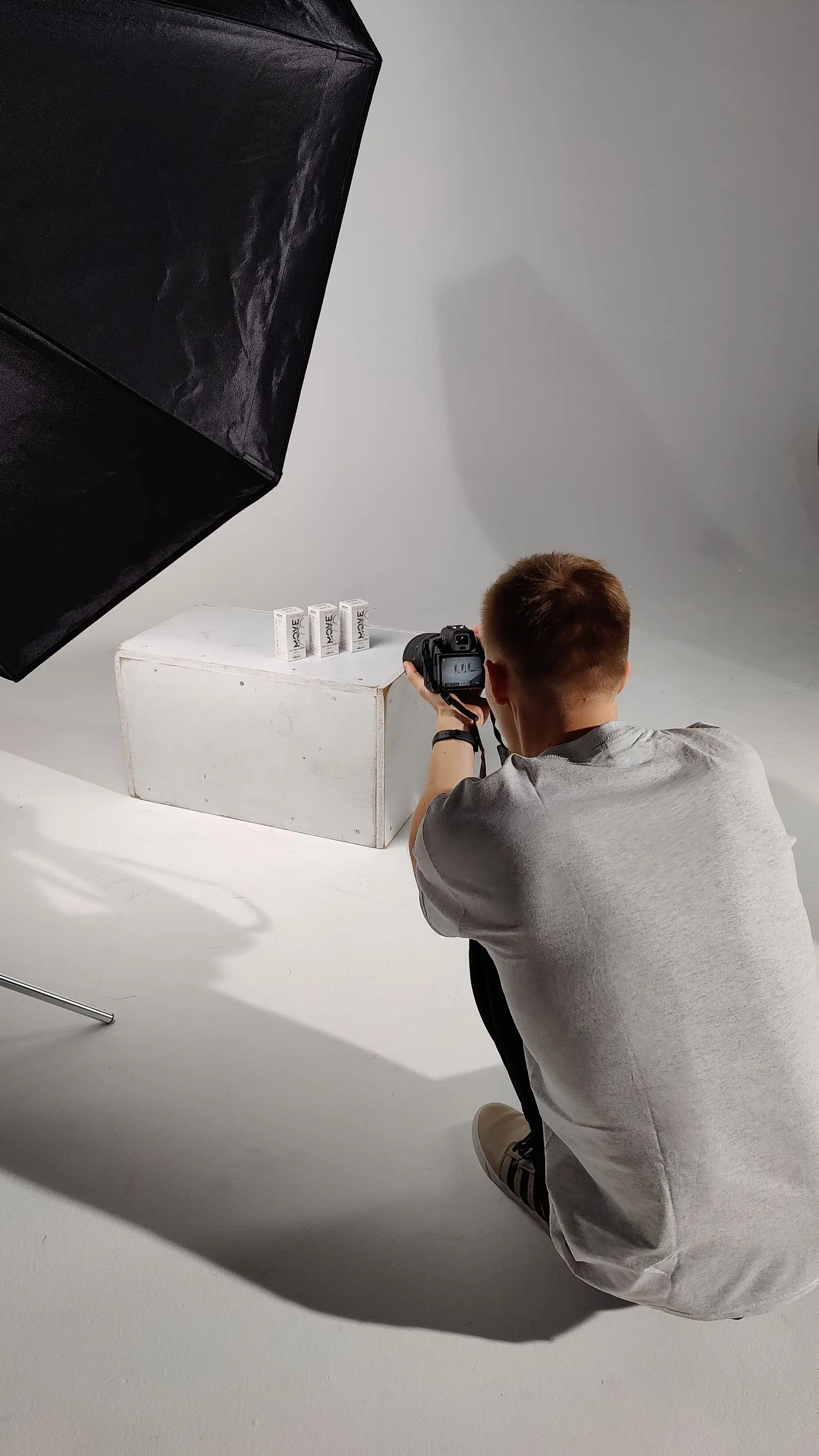 Photographer shooting a product on a studio set