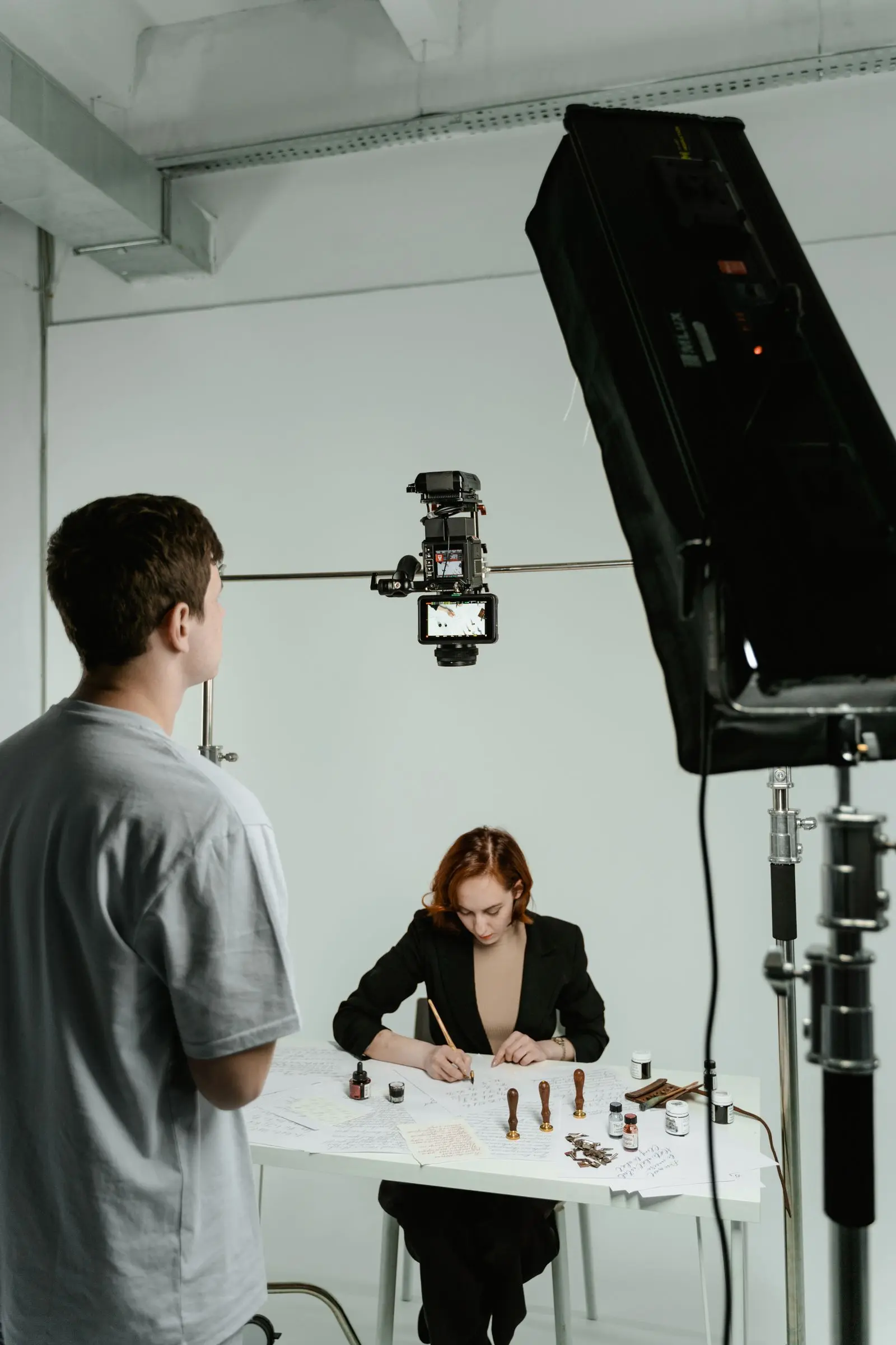 Video crew filming on a lit studio set