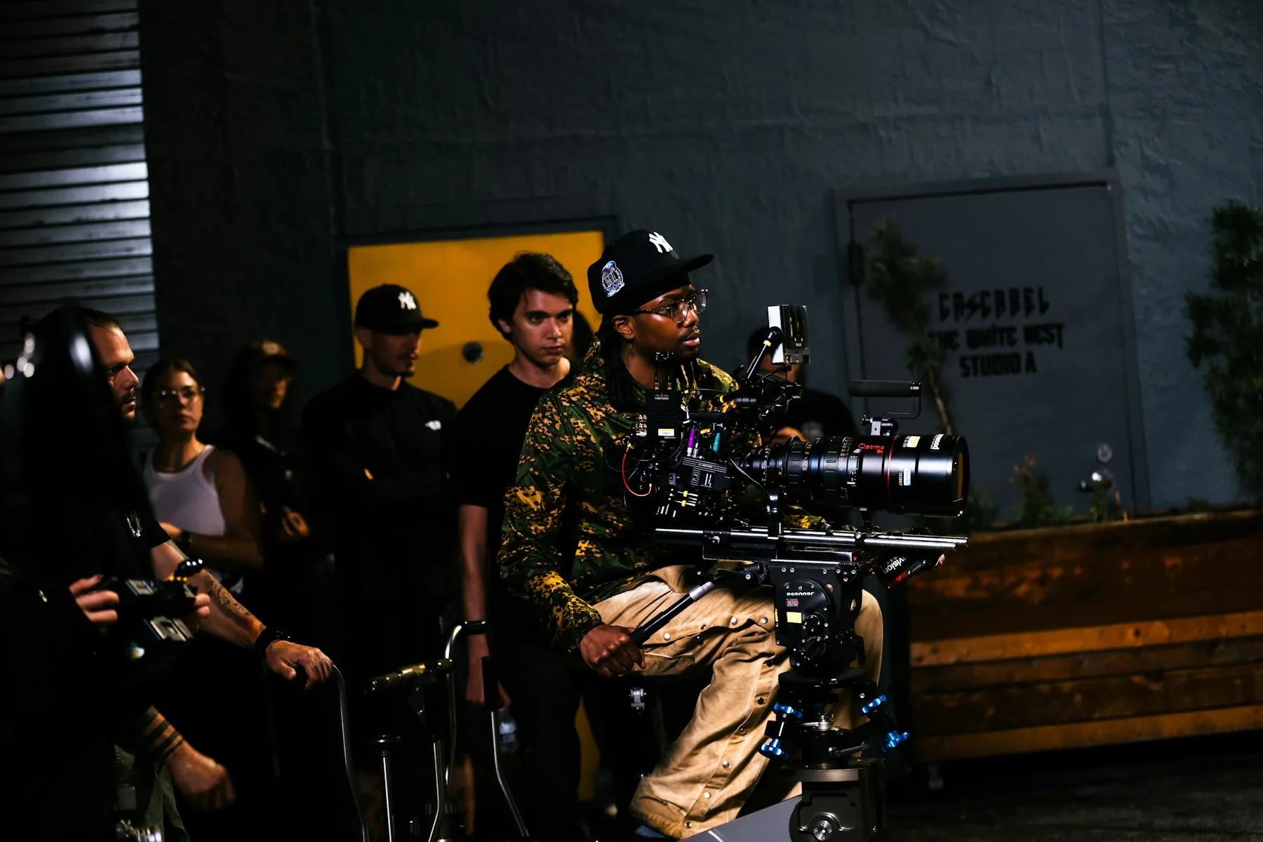 Film crew operating a cinema camera during on-set video content production