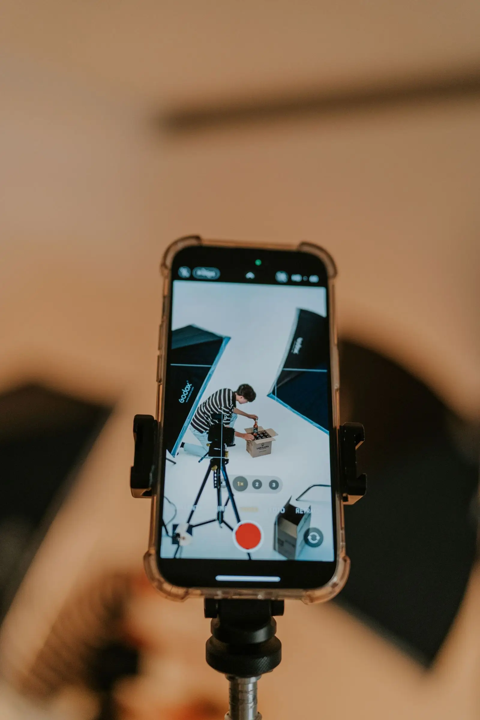 Phone filming a product unboxing in a studio